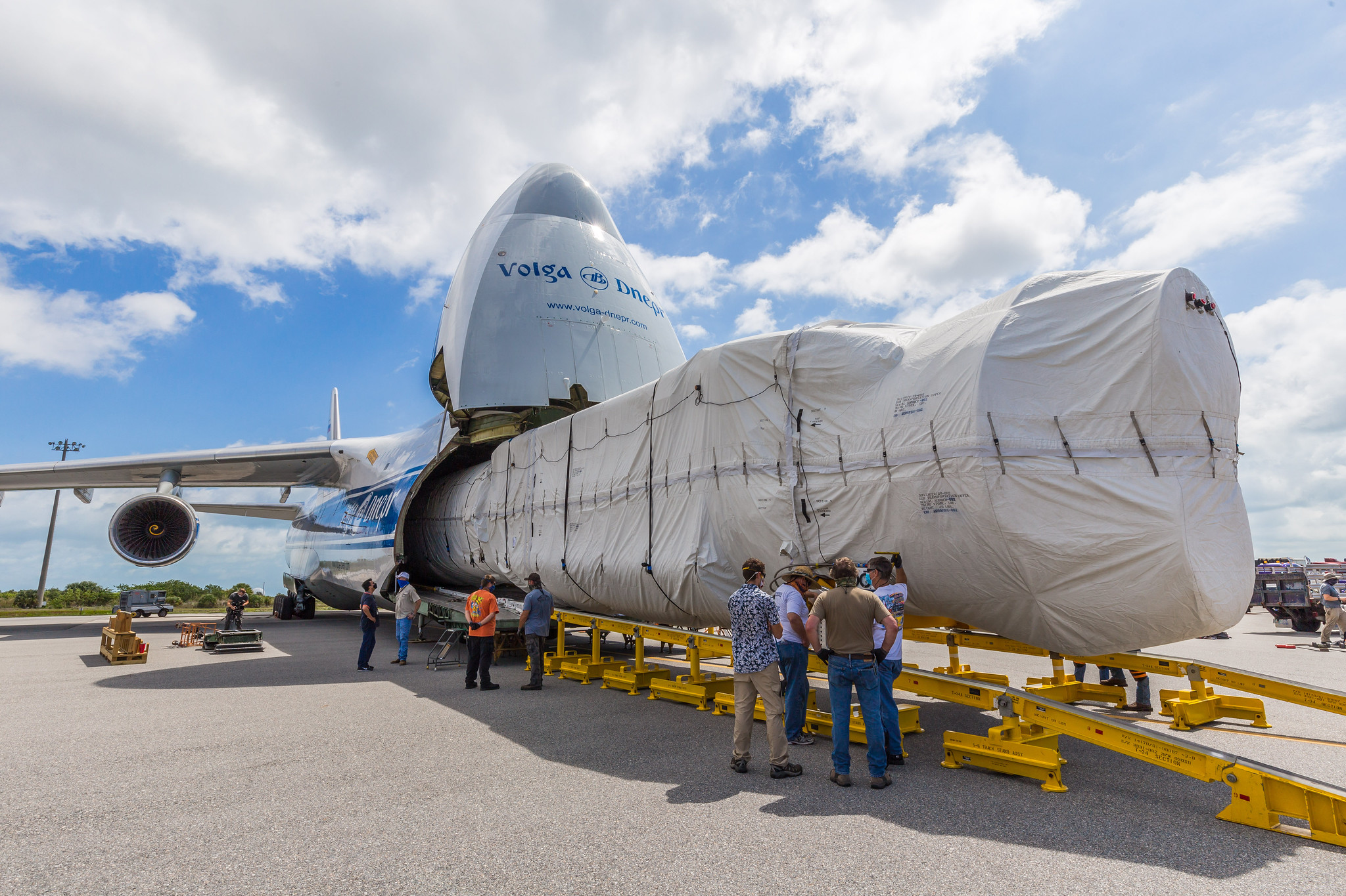 The Atlas V first stage emerges from the transport aircraft. Photo by United Launch Alliance