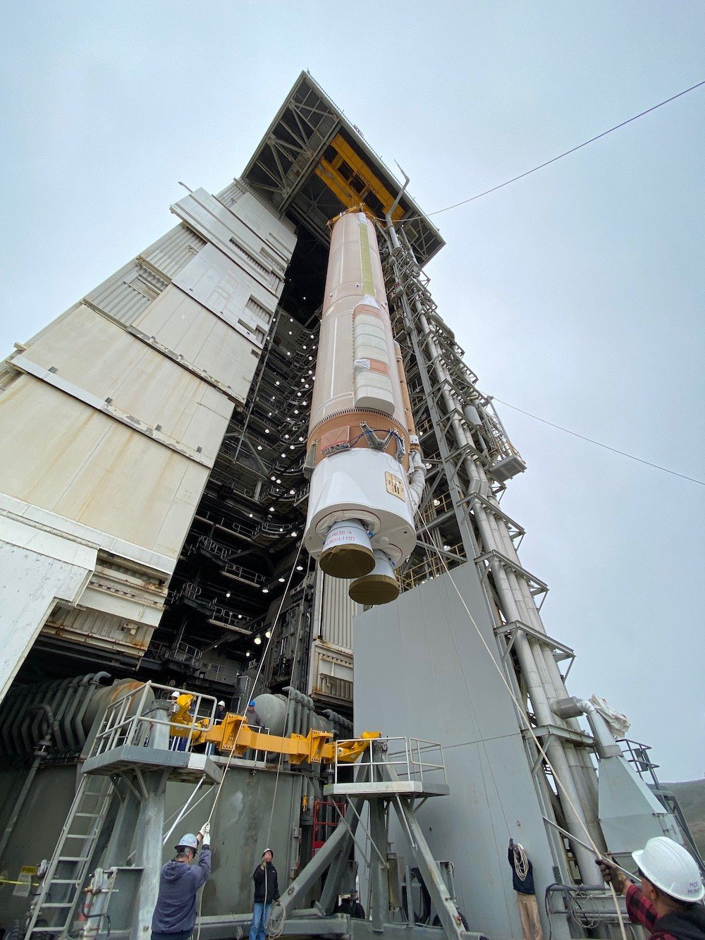 The Atlas V first stage was raised vertically by the overhead MST crane and maneuvered it onto the FLP. Photo by United Launch Alliance. 
