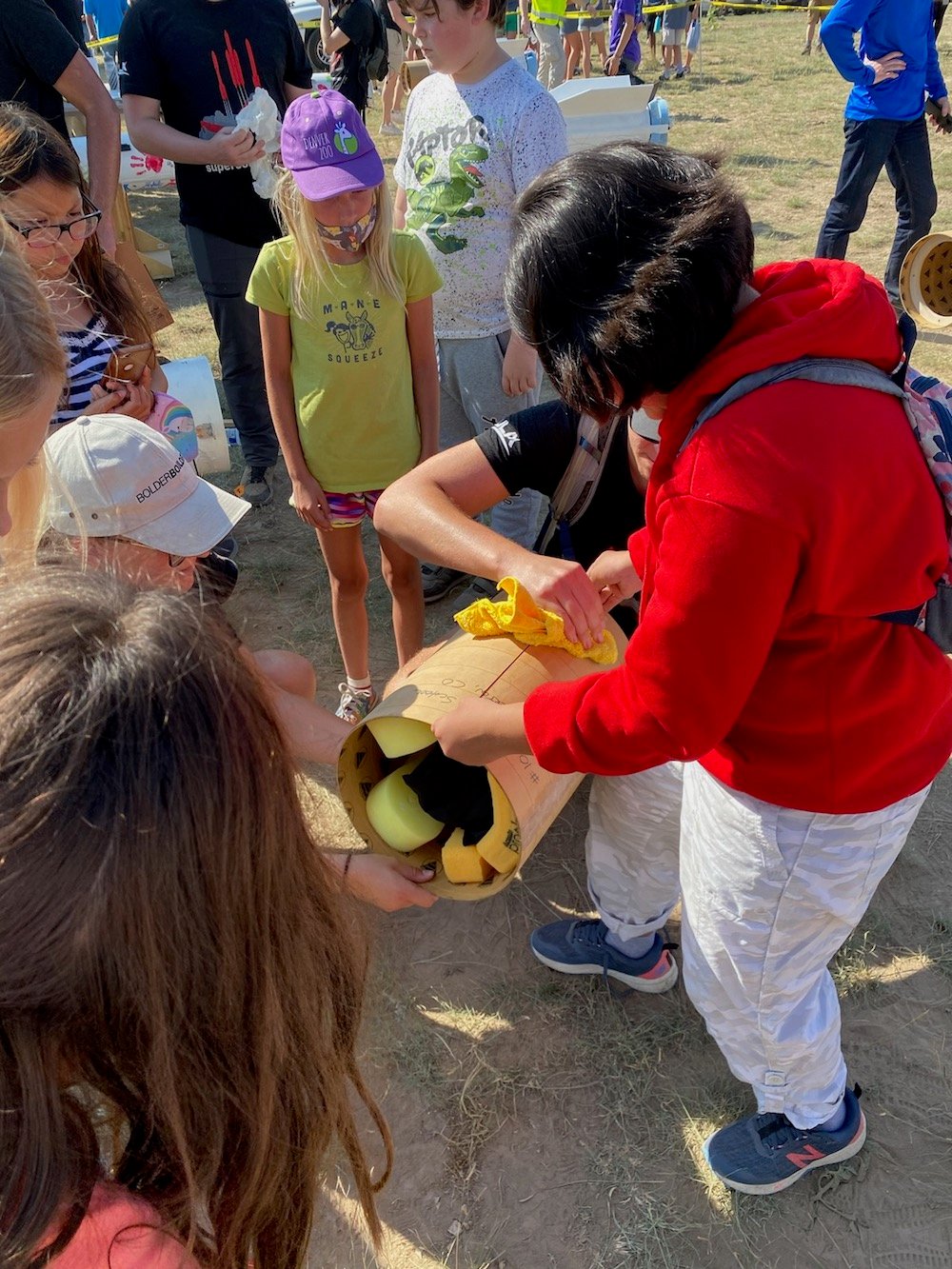 Silverton School students load their payload into the ULA intern-built sport rocket “Bacon” in preparation for launch. Courtesy photo by Whitney Gaskill.