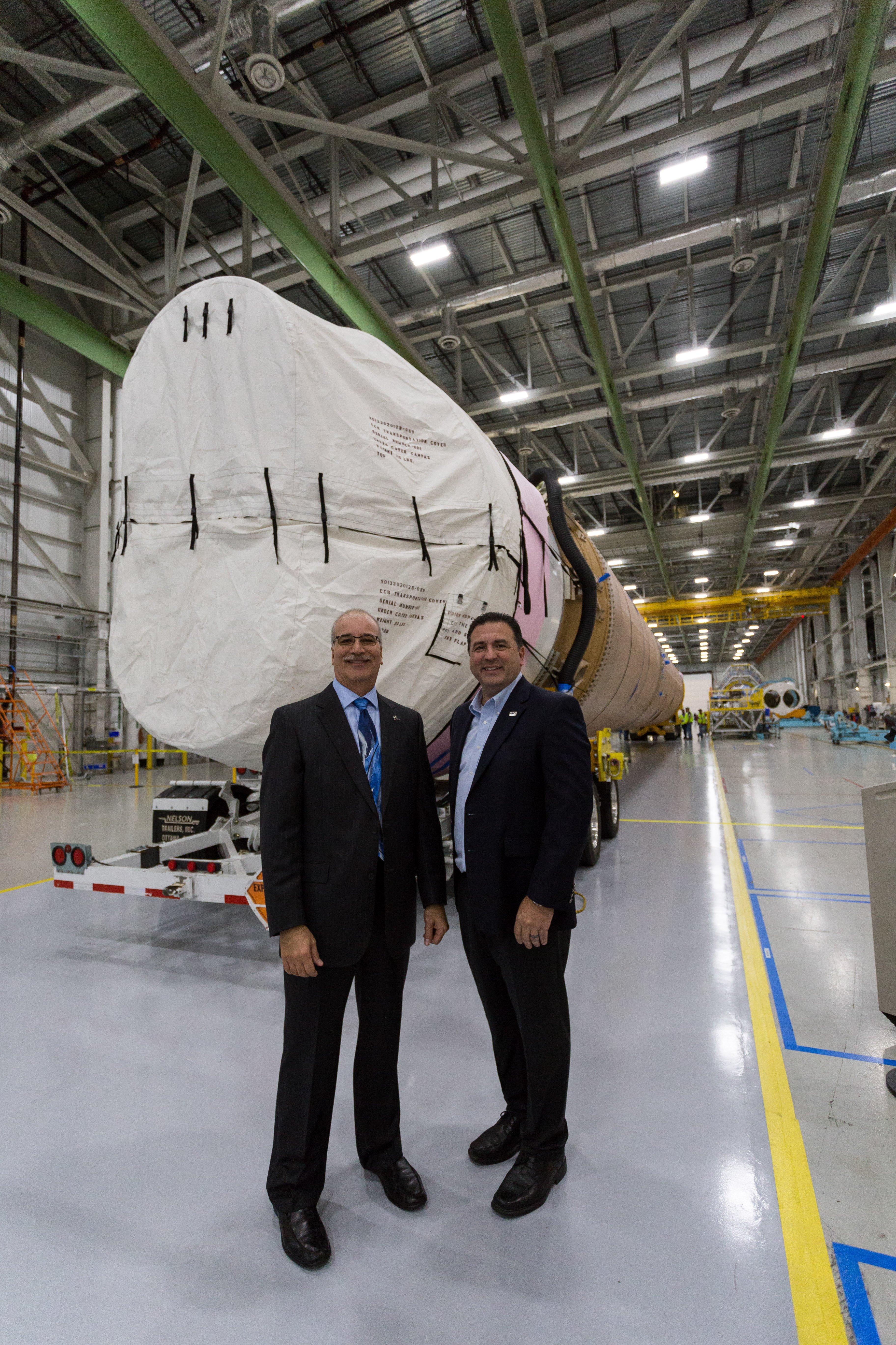 Boeing's Rick Navarro and ULA's Gary Wentz addressed dignitaries and the news media in front of the CFT booster in the factory before rollout. Photo by ULA