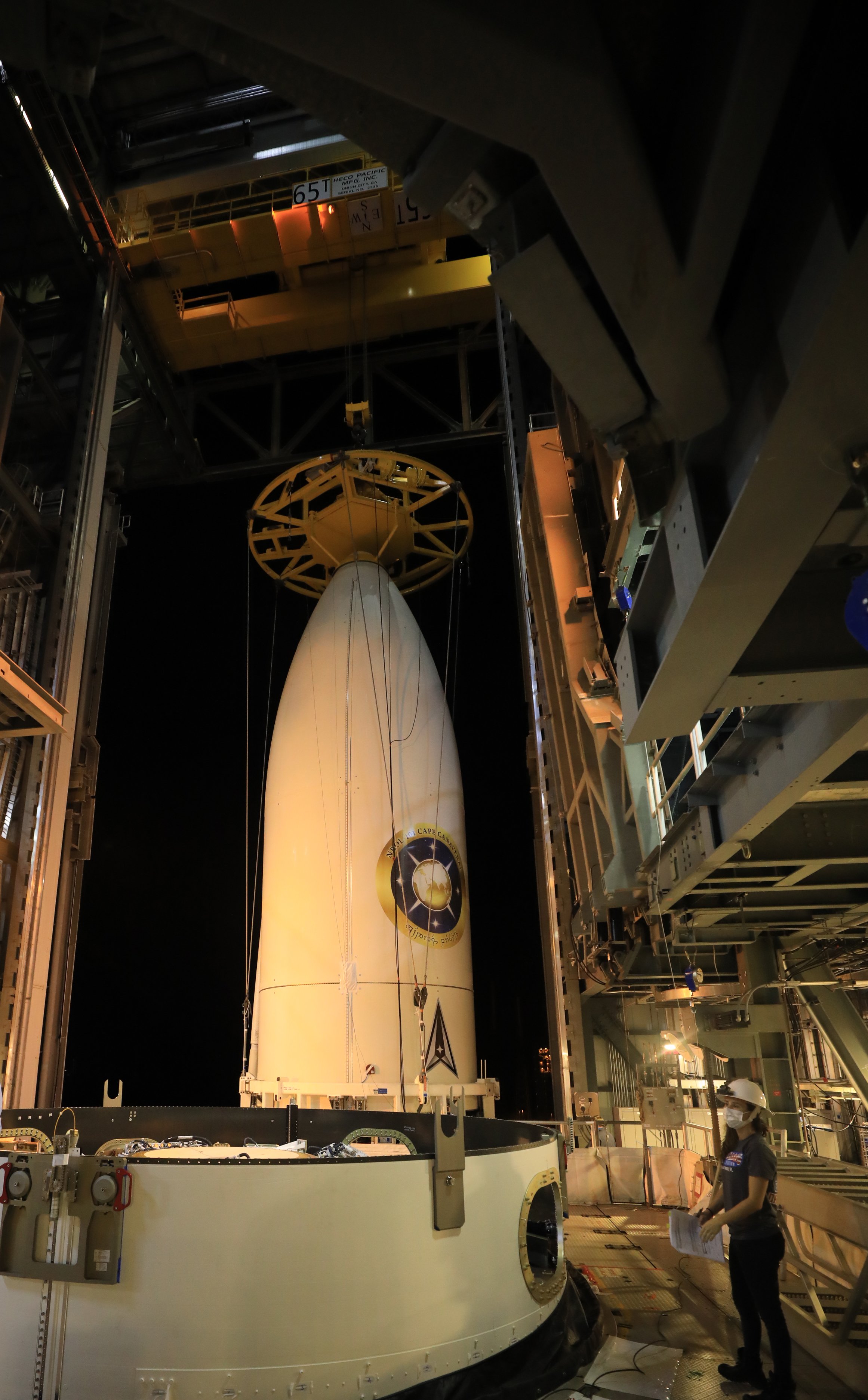 The encapsulated NROL-101 payload is hoisted into the Vertical Integration Facility for attachment to its Atlas V rocket. Photo by United Launch Alliance