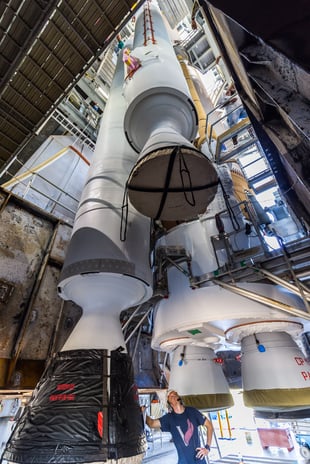 A GEM 63 solid rocket booster is maneuvered into position for attachment. Photo by United Launch Alliance